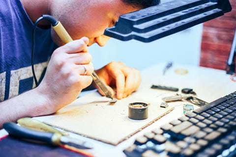 Image Of Engineer With Soldering Iron